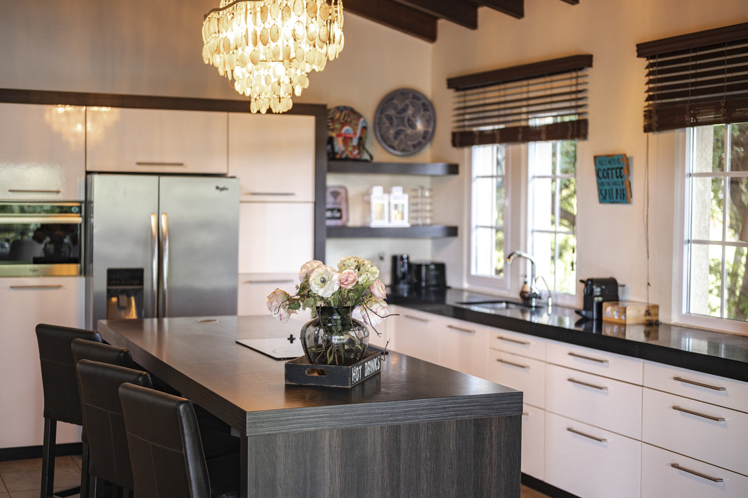Kitchen island beneath the chandelier at Bayside Hill