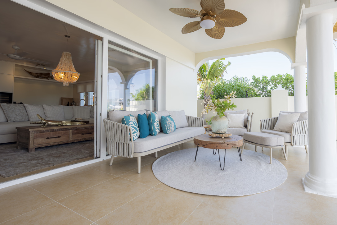 Covered porch lounge beside the living room at Castaway Beach