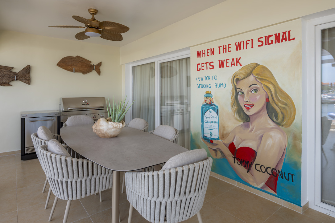 Covered porch with dining space at Castaway Beach