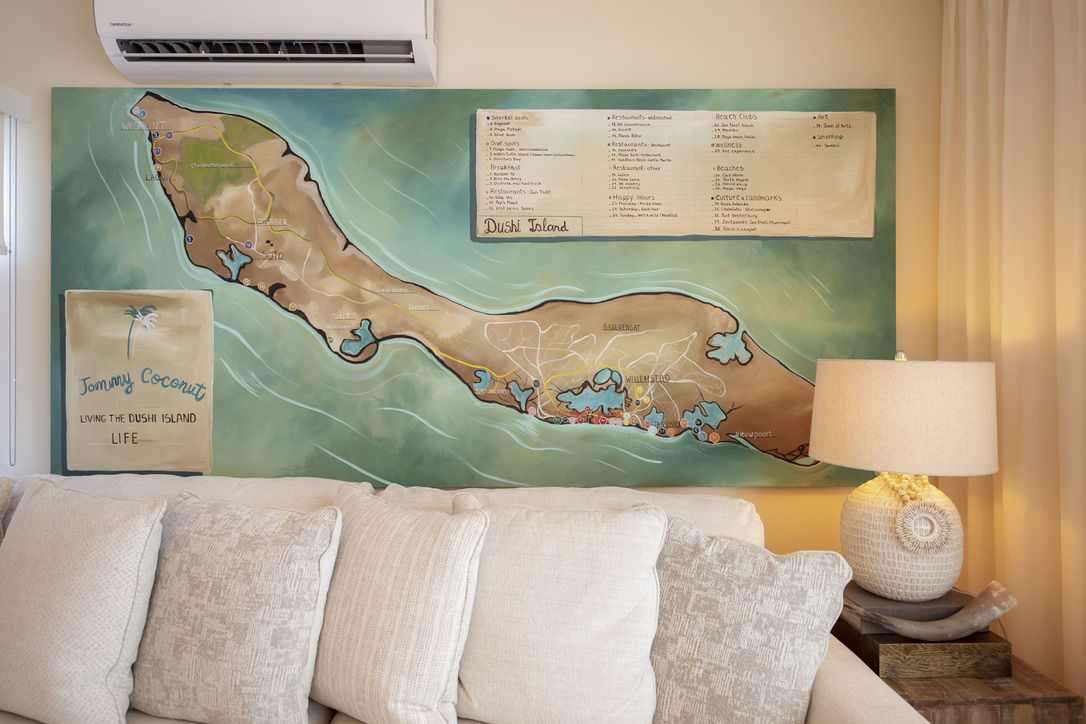 Hand-painted Curaçao map above the sofa at Castaway Beach