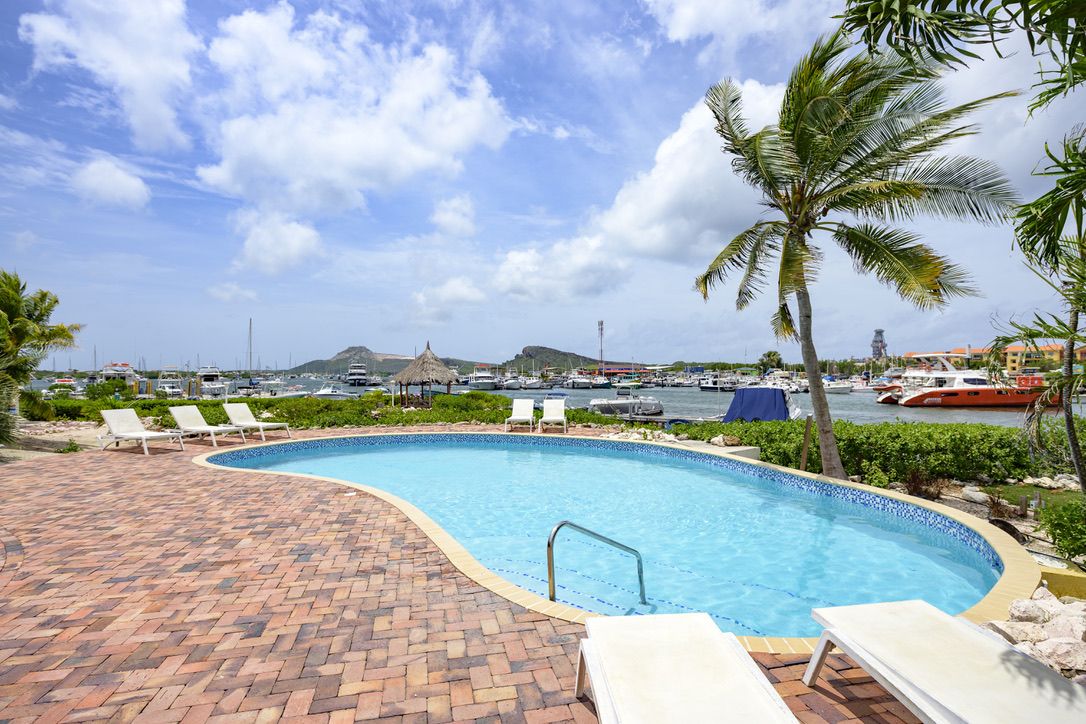 Shared resort pool overlooking the marina at Castaway Beach