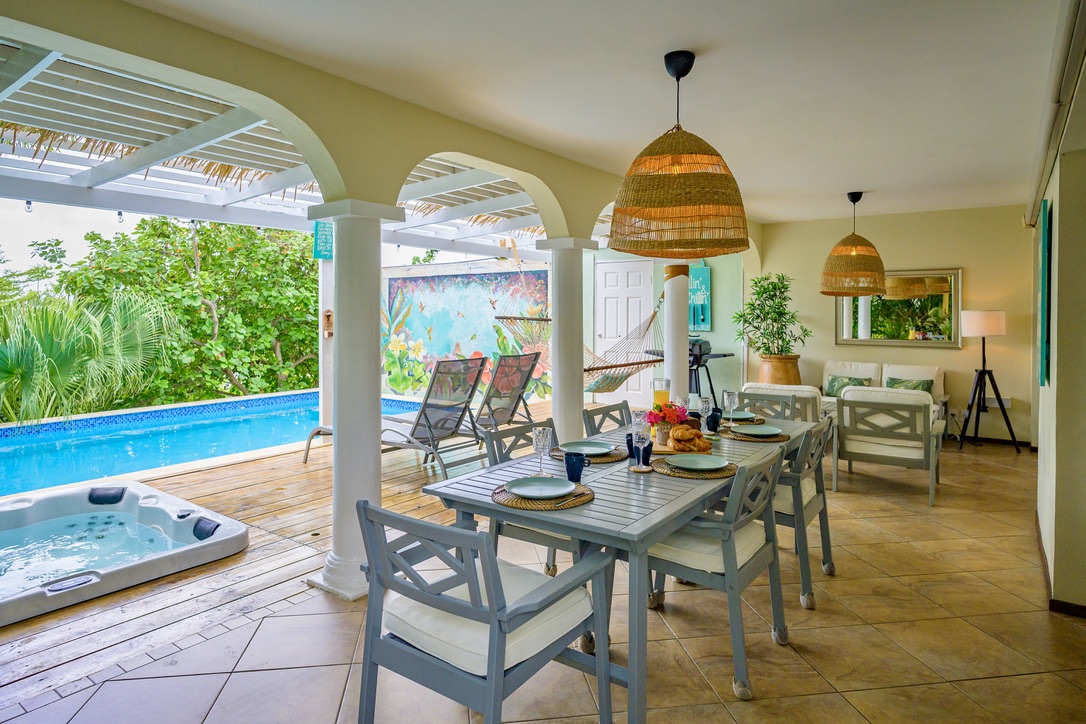 The veranda, dining table and hot tub