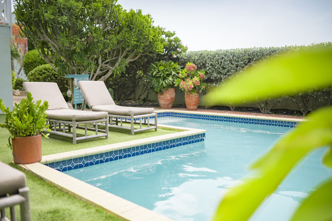 Private pool and sun loungers at Happy Hideaway