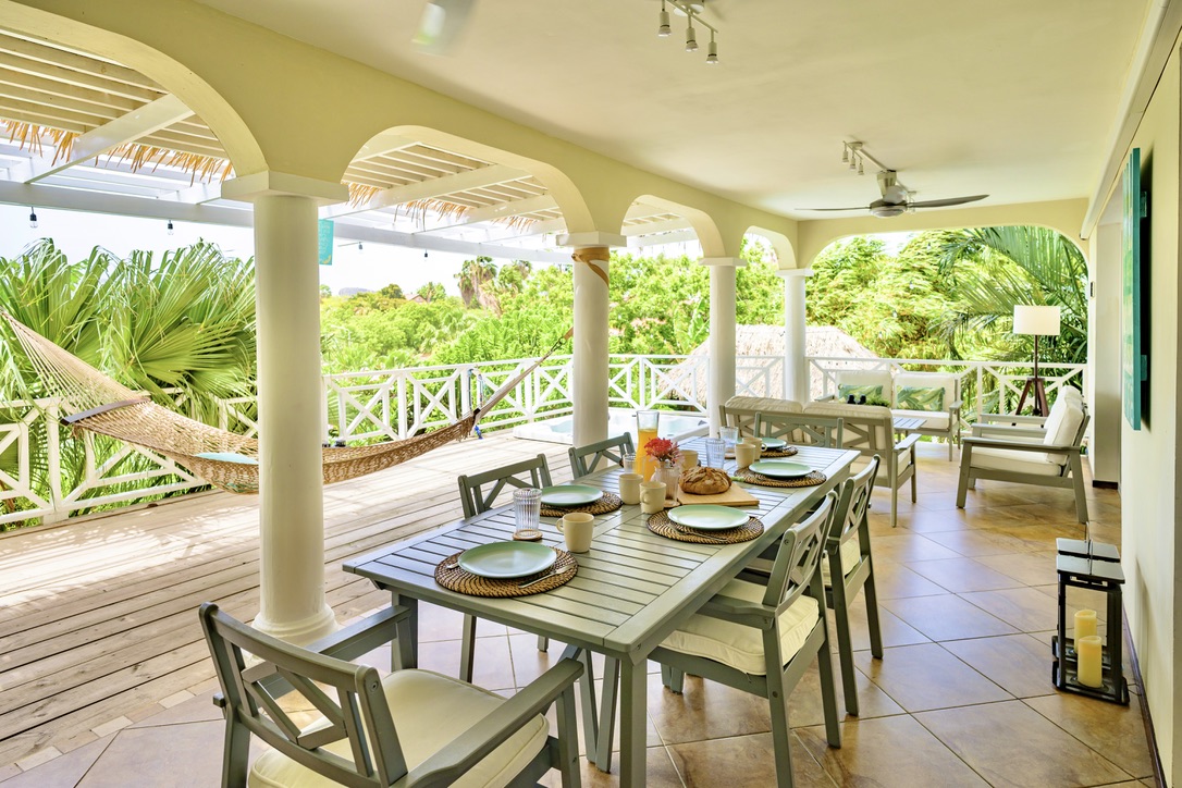 Covered terrace dining and hammock at Happy Hideaway