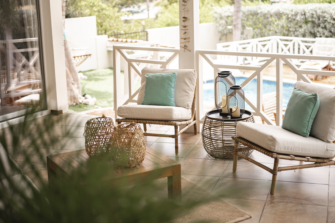 Veranda chairs overlooking the pool at Palm Breeze