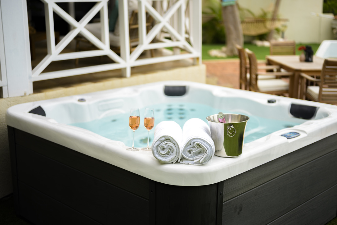 Hot tub with towels and glasses at Palm Breeze