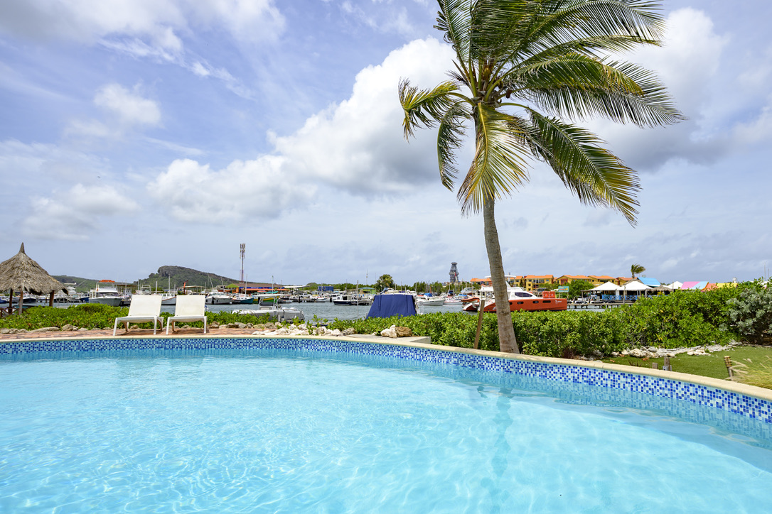 Shared resort pool overlooking the marina at Tropical Haven