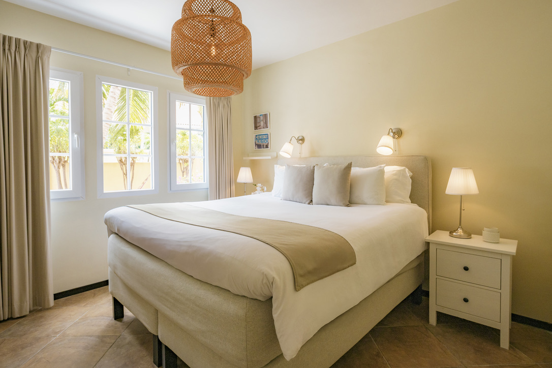 Second king bedroom with bright garden windows