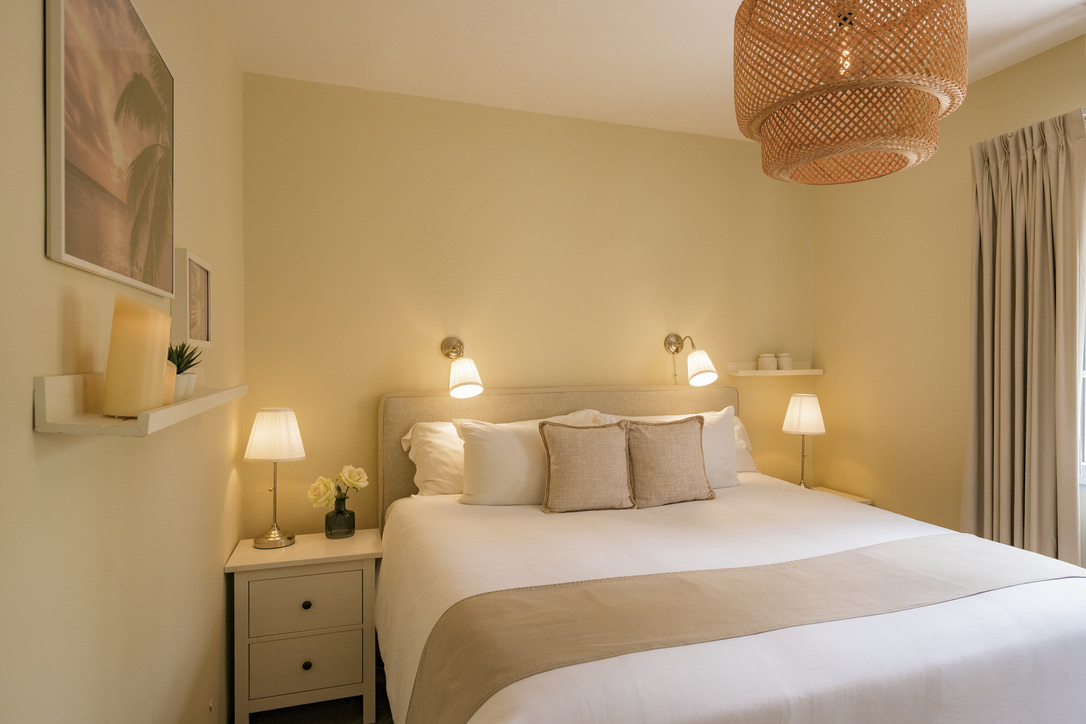 Third king bedroom with warm woven lighting